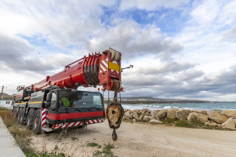 Heavy duty mobile crane parked near the sea. Telescopic truck mounted crane